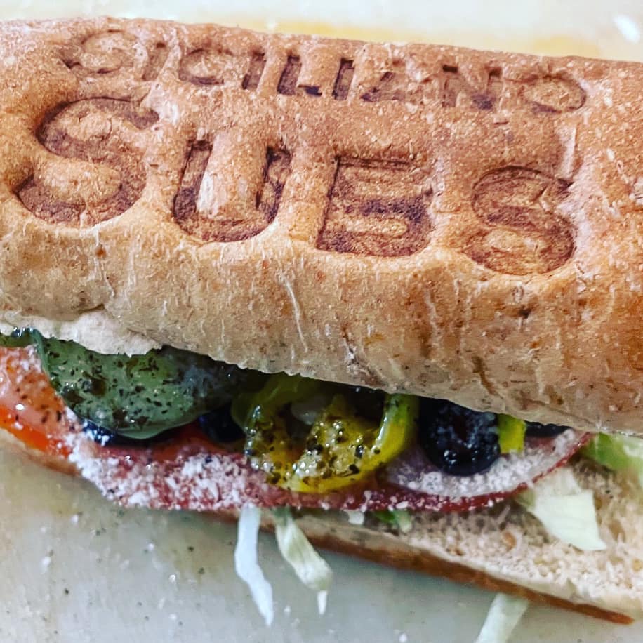 Sub sandwich branded with Siciliano Subs logo